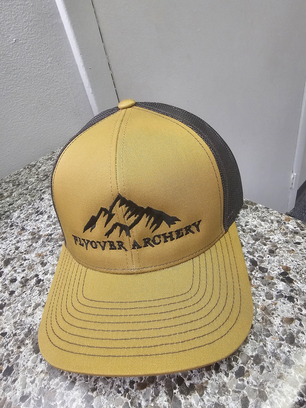 Flyover Archery hat in Bourbon with black logo.
